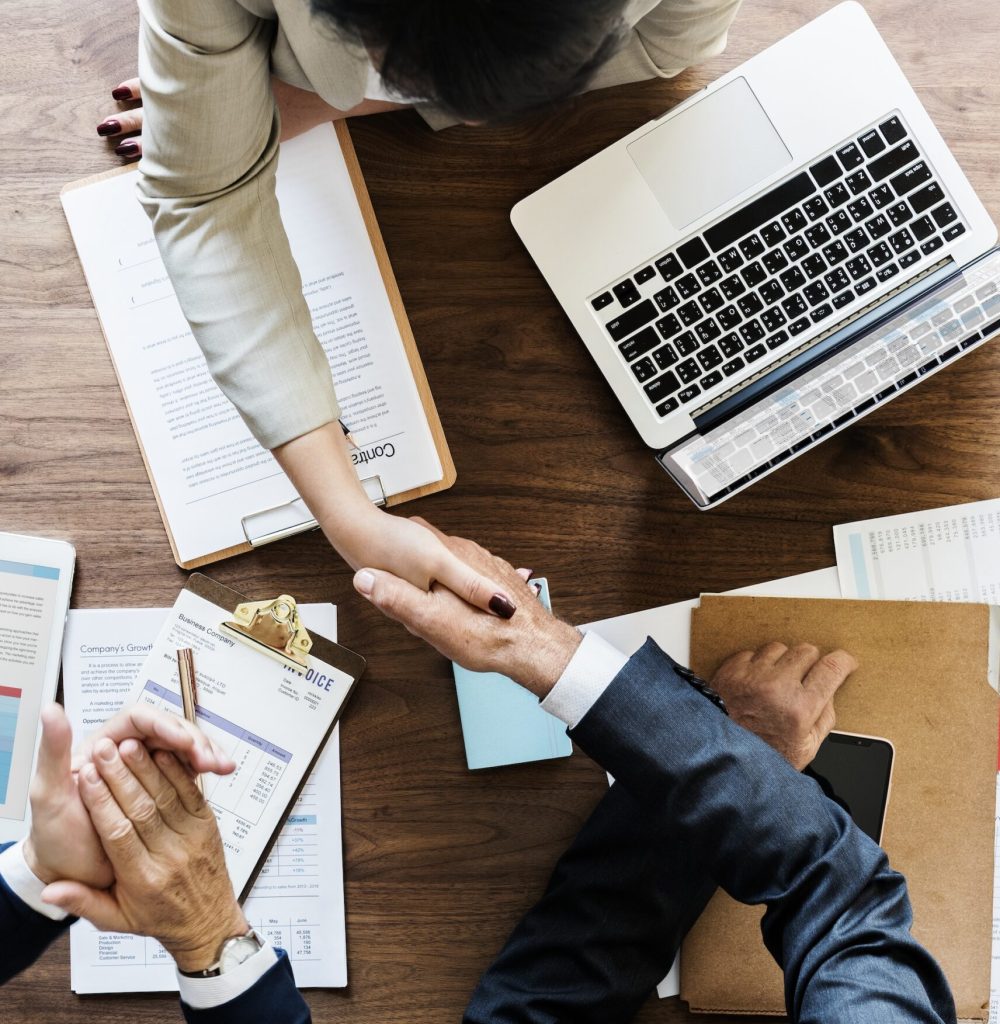 Business people shaking hands together